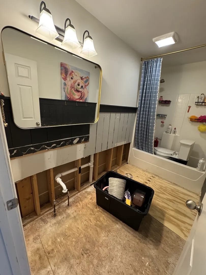 Before water damage - Buttonwood bathroom with exposed subfloor